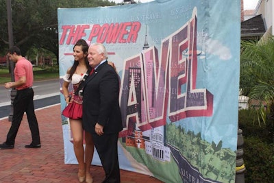 After speaking at Pointe Orlando, U.S. Travel Association president and C.E.O Roger Dow posed for photos in front of the campaign's banner.