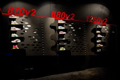 Inside Studio 580, New Balance previewed its fall collection to editors. Inspired by the new line, designers built laser-cut wooden structures to emulate the netting details in the shoes. Each wall unit contained shelves to house the various shoes and other products.