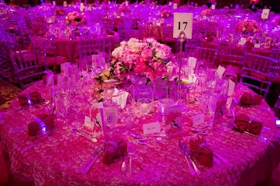 Pink linens, napkins, and floral centerpieces decorated each tabletop in the ballroom for the dinner portion of the fund-raiser.