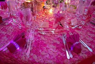 Matching the theme and the gobo lights shining on the walls of the space, illuminated bracelets that read 'Dream' served as napkin holders at each place setting.