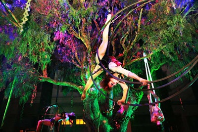 A performer from Lucent Dossier entertained the crowd from within a moon decor piece.