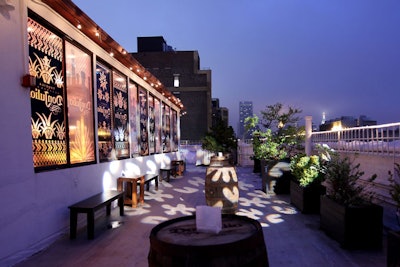 The 12th-floor outdoor terrace was also decorated to match the space, incorporating barrels and wooden benches for guest seating.