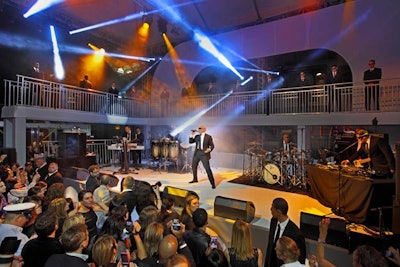 Pitbull, who wrote and recorded Men in Black 3's theme song 'Back in Time,' performed at the event. As a fun way to include an iconic visual from the film, the rapper and his band wore black suits and shades as did the 15 actors that stood watching the act from the stage's mezzanine.