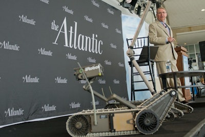 Joe Dyer, chief strategy officer at iRobot, shows off an example during a presentation at The Atlantic's Innovation Summit.