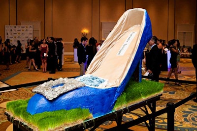 For the V.I.P. reception, the hotel's catering department recreated the Runway to Hope logo out of styrofoam and covered it with royal blue icing. The shoe, measuring six feet long and more than four feet high, held a basket of blueberry macaroons.