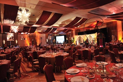 Organizers draped red and gold fabric overhead in the ballroom, looking to make the space feel like a luxurious tent. The warm hues worked well with the colour palette of the venue.