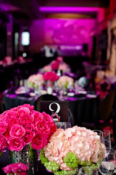Tables surrounded the V.I.P. runway. The floral arrangements used a mix of flowers, all slightly different shades of pink.
