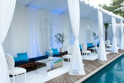 For a recent pool party, the team at Swank Productions kept the decor streamlined, with a mostly white color palette, mirrored furnishings, and plenty of sheer draping.