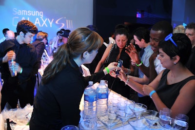 To showcase 'S-Beam,' a Galaxy S III function that allows users to transfer files by touch, the event offered a 'beam bar.' Attendees used the new phones to order drinks and bartenders would collect the orders by tapping their devices against them.