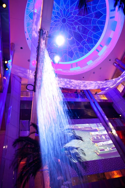 A 20-foot water wall, along with palm trees and hanging orchids, provided dramatic atrium decor.