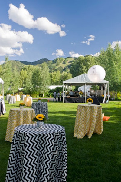 Chevron-patterned linens were also used on cocktails tables, and sunflower bouquets served as centerpieces.