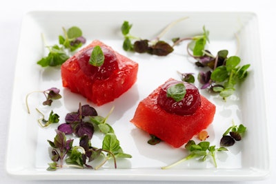 For a light summer appetizer, Wolfgang Puck offers compressed watermelon topped with a sangria sphere made from red wine infused with apples, oranges, grapes, and strawberries.