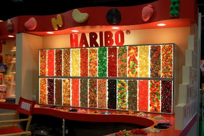 Haribo's candy wall had a built-in counter with buckets containing its chewy candy for sampling.