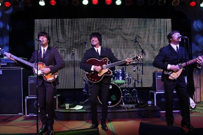 A Beatles tribute band—this one comprising male singers—also appeared at the Make-a-Wish Foundation of South Florida's gala at the InterContinental Hotel Miami in 2009. Event producer Bruce Sutka of Sutka Productions International decorated the lobby with Union Jack flags and LED walls displaying scenes representing the British Invasion. Stretched spandex created a tunnel over the escalators, at the top of which stood a facade of the Fab Four's famous London studio, Abbey Road. Floor-to-ceiling draping separated the mezzanine level into multiple spaces, each representing a different Beatles song, such as “Lucy in the Sky With Diamonds” and “Strawberry Fields.”
