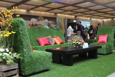 AFR set up a central lounge space for attendees using its new grass furniture, which is just launching in Los Angeles. Turf-covered seating groups sat atop a turf floor, and colorful pillows made the look pop.