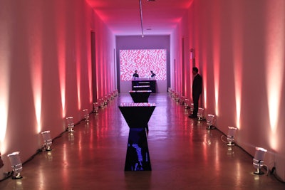 Just outside the gallery, lighting designer Bentley Meeker illuminated the corridor walls with red and blue floor lamps.