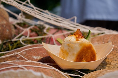 Yuhi Fujinaga of the Sea Grill served swordfish pastrami sandwiches with pickled ramps and whole grain mustard. To match the theme inspired by The Perfect Storm, the bites were served on mini 'boats' and placed on an ice sculpture, which was decorated with shells and netting.