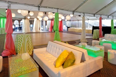 For the Central Park Conservancy's annual 'Taste of Summer' event in New York, designer Marc Wilson punched up the all-white furnishings with drapes and throw pillows in bright pink, green, and yellow hues.