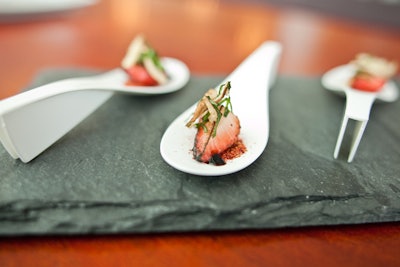 Pure Kitchen Catering prepares food using fresh ingredients from local farmers and producers. One of their new seasonal items is a one-bite charred strawberry appetizer, made with shitake mushroom, truffle oil, clove, balsamic vinegar, and basil.