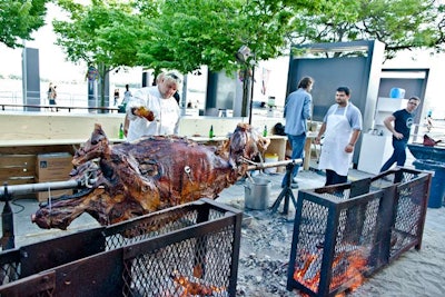 In the patio area of the main party, Marc Thuet (pictured, left) doused a roasting bison with bourbon. Throughout the night, guests had the opportunity to watch the chef prepare and serve the bison from seats on the patio.