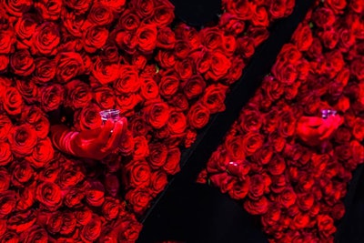 Gloved hands poked through a rose-covered wall to offer shots and desserts at the Zing vodka launch.