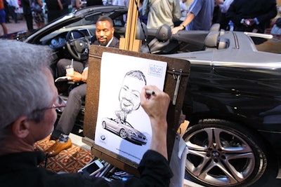 A caricaturist drew portraits of guests posing in one of the multiple BMWs parked at the event.