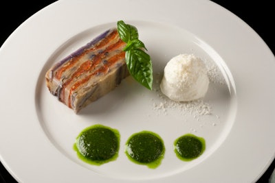 SD26 Events' eggplant terrine features sauteed eggplant that is layered with fresh tomatoes and herbs then baked in the oven. The dish is served with a dab of basil pesto and garnished with a parmigiano reggiano-flavored milk foam.