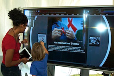 At the AIDS Memorial Quilt display in Washington, visitors can learn more about the quilt's 25-year history by using an interactive timeline displayed on a touch-screen monitor.