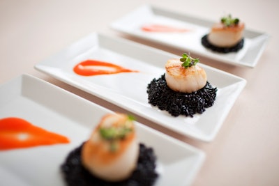 Instead of a plated dinner, Cuisine Chez Vous can offer passed small plates like local gingered scallops, black rice pilaf, roasted red peppers, and saffron coulis.