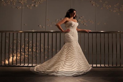 Photo of a bride posing along the gorgeous wall in the second-floor private reception area.