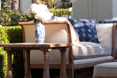 Outside, the cocktail area was kept simple with a French-countryside-inspired theme marked by a color scheme of blue and white, and rustic wood furnishings.