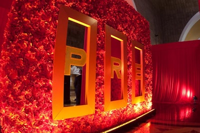 Inside, the entrance was covered with orange flowers and decorated with letter decals to spell out the event's official name, PRE.