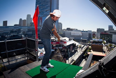 On Chick Hearn Court, Rickie Fowler drove golf balls from the top of the Big Air ramp, in an area surrounded by logos visible from all angles.