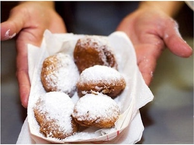 Deep-fried Oreos topped with chocolate syrup and powdered sugar