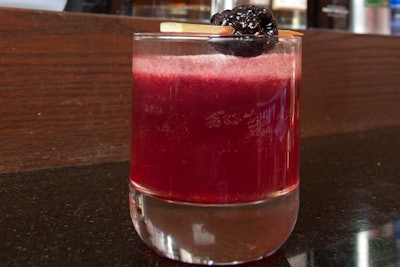 The 'Kuro Smash,' served at Chicago's Union Sushi & Barbecue Bar, blends bourbon and cognac with lemon juice, simple syrup, blackberries, and tarragon seeped in Everclear.