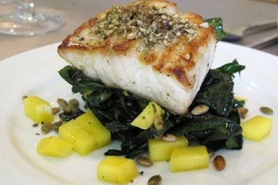 La Fête Catering's seasonal menu takes advantage of local striper season with an entree of wild striped bass served with kale, mango, and pepitas.