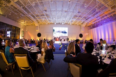 Underneath the basketball court is a tennis court, seen here transformed for a special tennis-themed dinner.