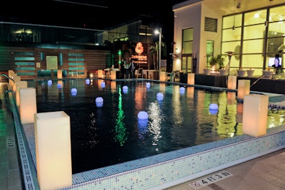 Night view of the pool decorated with tall candle pillars.
