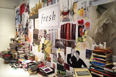 Situated at the far rear wall of the gallery was a 28- by 11-foot wood frame wall with a foam-core center that mimicked a large bulletin board. Graphics displayed on it represented the brand's 21-year journey, while dozens of inspirational design and fashion books were stacked haphazardly with Fresh products resting on top.