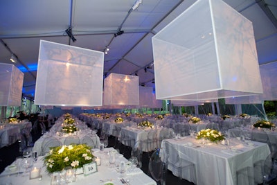 The Giselle gala at the Harris Theater this year boasted all-white decor with large, transparent cubes that were suspended from the ceiling in the dining area. Ferns and white freesia dotted the table tops.