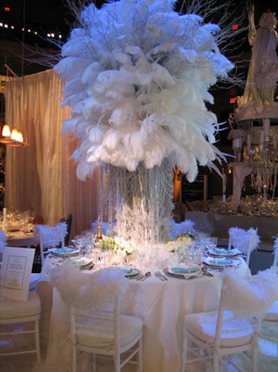 For Diffa's New York Dining by Design benefit in 2004, Robert Rufino of luxury jewelry company Tiffany crafted a towering centerpiece of white feathers and strings of iridescent beads. The structure was surrounded by small bunches of white flowers at the base. Other touches included marabou boas, which draped the backs of the chairs, and a white rug.