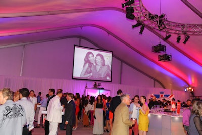 The after-party took place on the rooftop of the Harris Theater, which Dennis Remer of Frost designed using red and blue lighting to underscore the English theme. The main area, which housed bars and sponsor activations, was referred to as 'Piccadilly Circus Tent.' As guests had their pictures snapped at the Patron Photo Station, real-time images appeared on a 10.5 by 14-foot screen that Remer hung on one end of the tent.