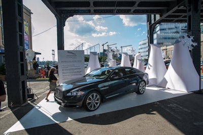 In the photo-op area, large iceberg-shaped sculptures serve as the backdrop, and guests can pose with one of the new sedan models.