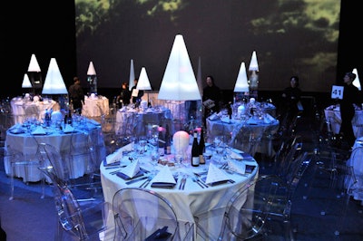 For the National Ballet of Canada's 'White Hot' gala in 2009, Three Event Planning & Design topped the dining tables with tall cone-shaped plexiglass towers that projected different colors onto white mannequin heads at the base of each structure.