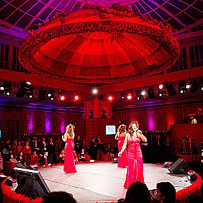 The American Heart Association brought attention to their Go Red for Women campaign in New York with a giant red flower- and fabric-covered dome constructed with 2,500 rosebuds, aged vines, and hanging amaranths hung above a circular stage.