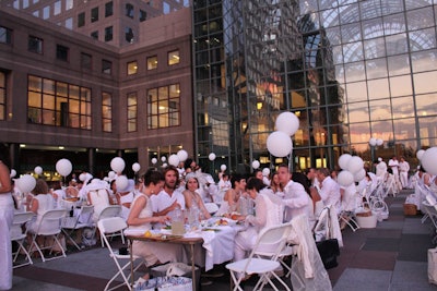 For New York's first Dîner en Blanc at the World Financial Center Plaza last year, guests were asked to wear white clothing and bring a list of items—including white plastic folding chairs and square tables, white tablecloths and napkins, white dinnerware.