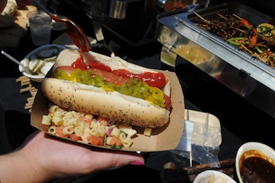 The beach party had a buffet of classic picnic snacks such as hot dogs, hamburgers, pasta salad, and fruit.