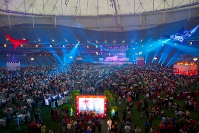 The Tampa Bay Rays major league baseball team played inside Tropicana Field Saturday evening, giving organizers just 24 hours to transform the space before guests arrived for the welcome event on Sunday. Tension structures and lighting highlighted three distinct spaces intended to represent the region's three main cities: Tampa, Clearwater, and St. Petersburg. Entertainment took place on a main stage behind home plate, and at two smaller stages elevated 16 feet off the ground.