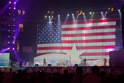 Behind the main stage at Tropicana Field, a 40- by 60-foot American flag served as a patriotic backdrop for the performances.