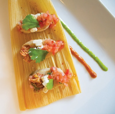 Vegetable-filled tamales served with green mole sauce and cilantro, by Naturally Delicious Caterers & Events in Brooklyn